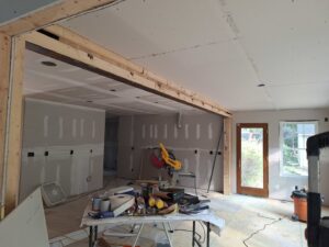 An interior room under construction with new drywall installed and taped by Albis Morales Painting LLC in Raleigh, NC.