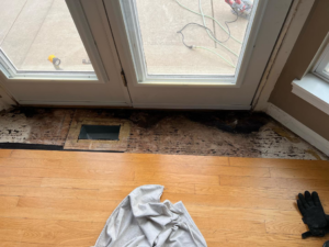 Interior floor demolition and repair work near a doorway by Silhouette Builders, Inc. in Yorkville, IL