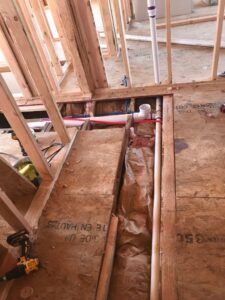 Interior framing and plumbing rough-in during a remodel by Prenga Remodeling in Orange, CT