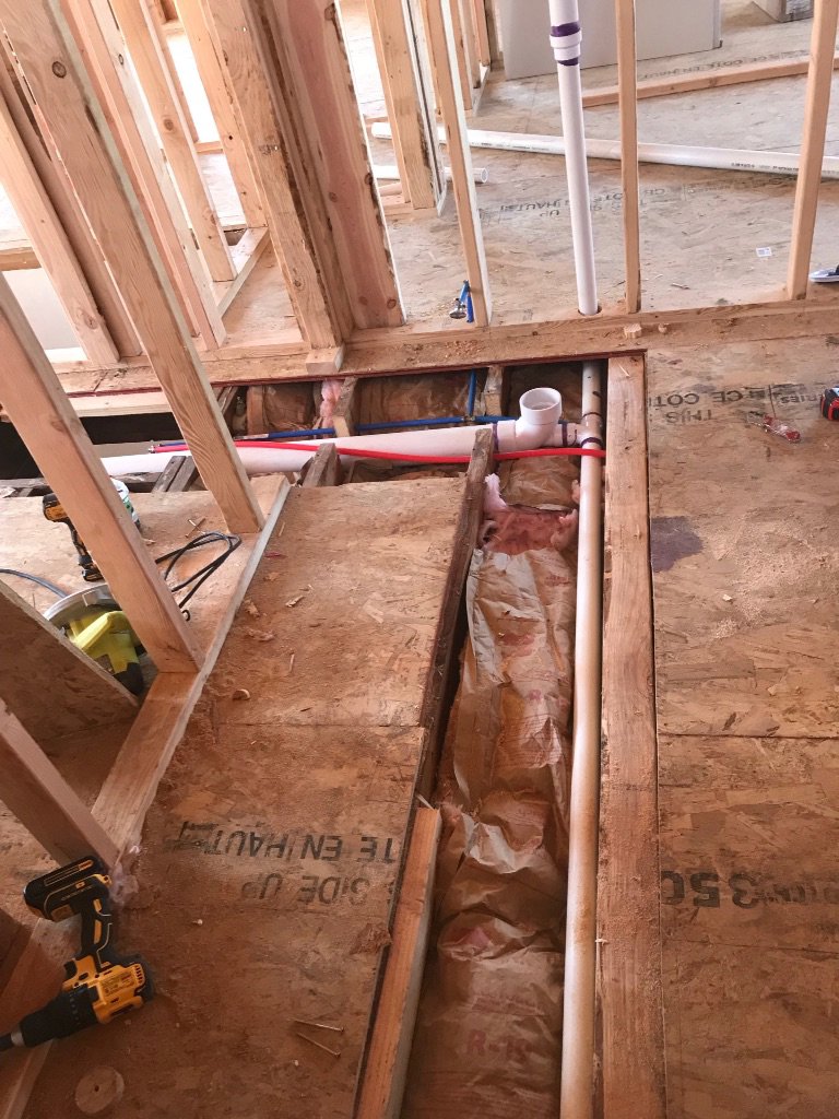 Interior framing and plumbing rough-in during a remodel by Prenga Remodeling in Orange, CT