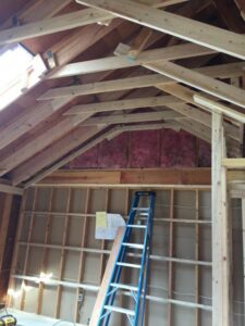 Interior framing and roof trusses of a building under construction by Carl Gardner Contracting in Syracuse, NY.