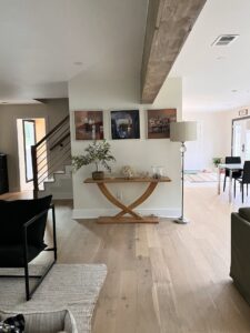 An interior hallway with new flooring and a staircase completed by Heroic Builders LLC in Greenville, SC.