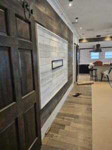 Completed interior hallway renovation with wood-look tile and a shiplap accent wall by Beyond Builders in Tampa, FL