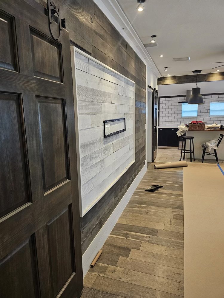 Completed interior hallway renovation with wood-look tile and a shiplap accent wall by Beyond Builders in Tampa, FL