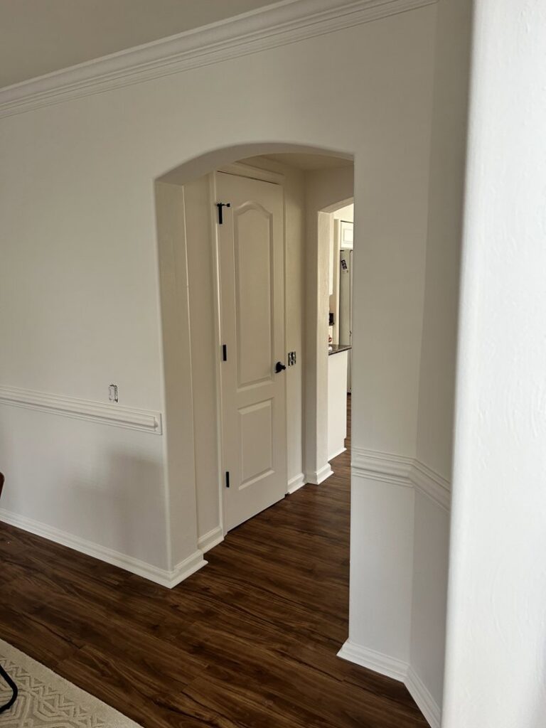 A freshly painted interior hallway with white walls and trim, showcasing a handyman painting service by Randy Overacre Painting Company in Virginia Beach, VA.
