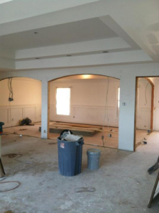 Interior home renovation showing new archways and exposed wiring by Castillo Construction Company in Malden, MA