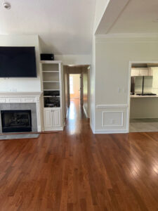 A renovated interior living space featuring new hardwood flooring and fresh paint, completed by Northcross Restoration Inc in Memphis, TN.
