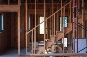 Interior house framing and staircase construction in progress by Orival Property Services in Boston, MA.