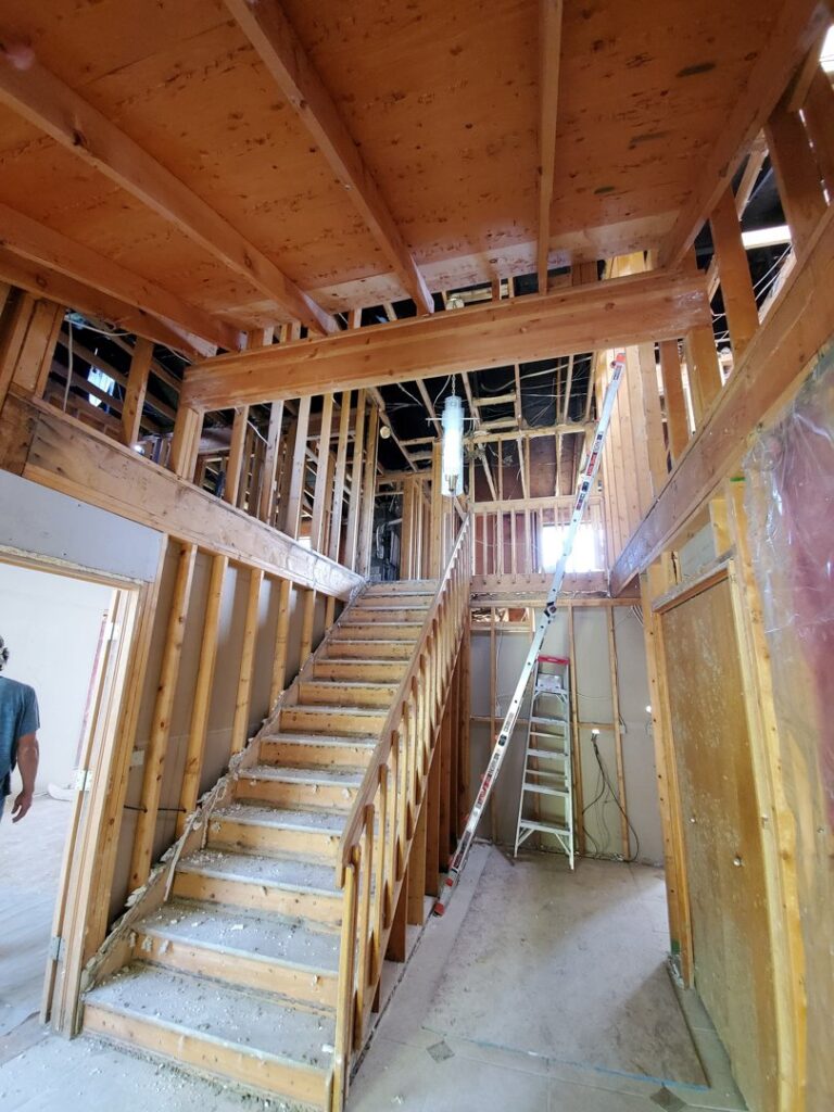 Interior house framing and stairs during a renovation project by Jonny Handyman Services in Roy, UT.