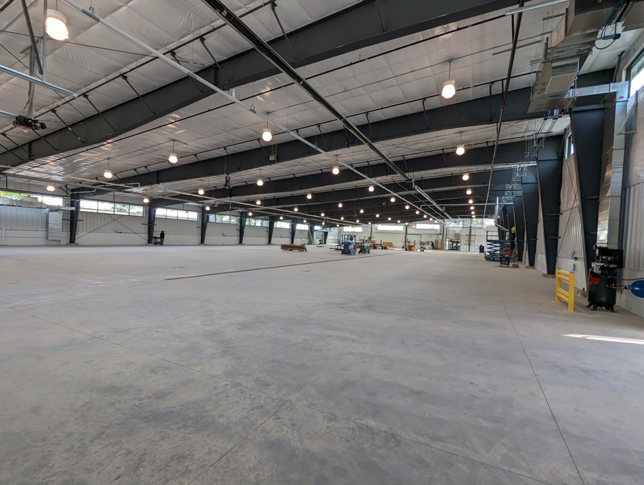Interior view of a large, empty commercial space, showcasing general contractor work by Integrated Building Systems, Inc. in Westmont, IL.