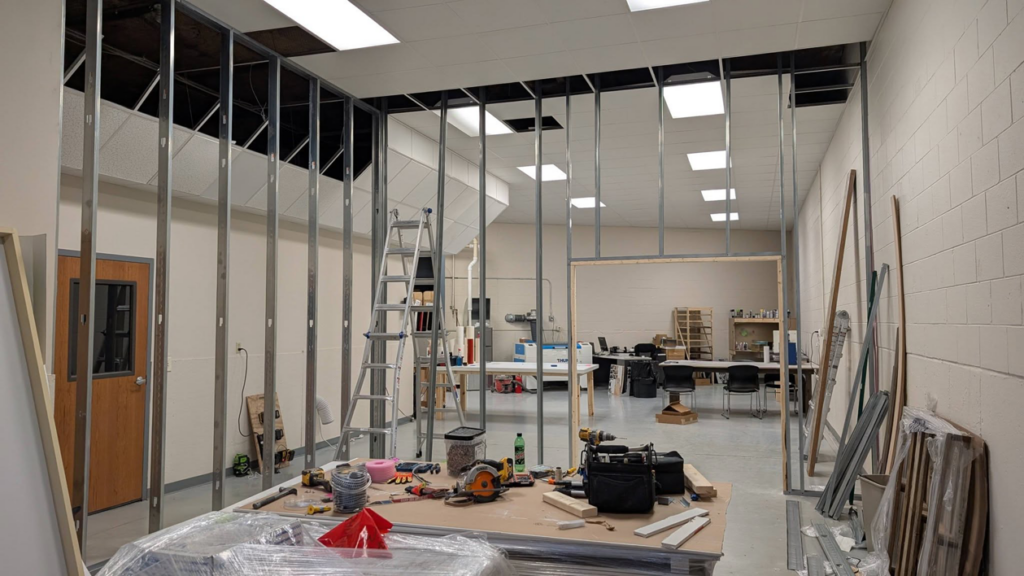 Interior metal stud framing in progress with tools on a workbench, handled by GCB Home Improvement in Appleton, WI.