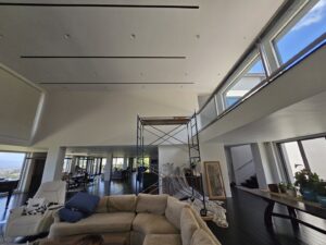 A spacious living room with scaffolding set up for interior painting or high-ceiling work by Just-In-Time Handyman Services in Honolulu, HI.