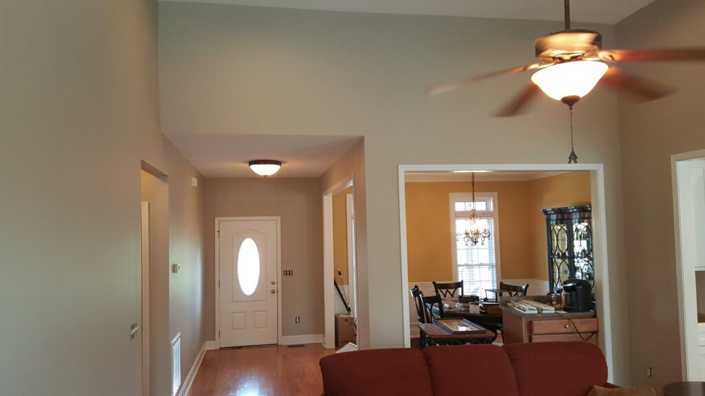 A renovated interior with fresh paint, new light fixtures, and wood flooring by Rapid Repairs and Renovations in Knoxville, TN.