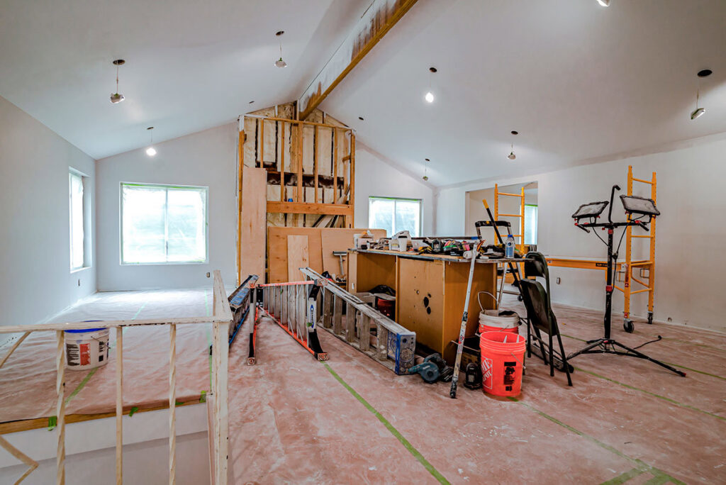 An interior painting project in progress with ladders and equipment, handled by GO Painting in New Haven, CT