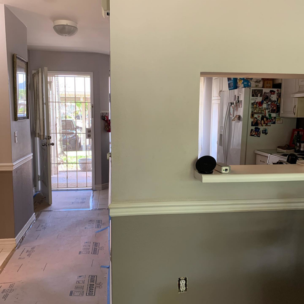 An interior painting project in a hallway with floor protection by Island Handyman in Honolulu, HI.