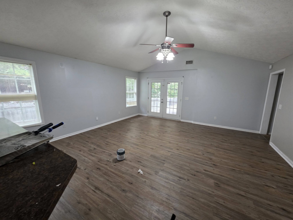 An interior room with a paint can on the floor, indicating a painting project by Turner Family Services LLC in Columbus, GA.