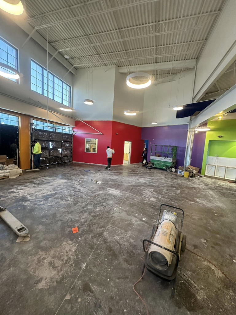 Interior painting and renovation services in a large commercial room by Husky drywall LLC in Kansas City, MO.