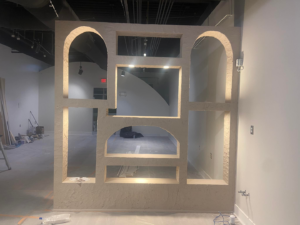 An interior remodeling project showing a decorative textured wall feature with arches and niches by DG Pro Remodeling in Charlotte, NC