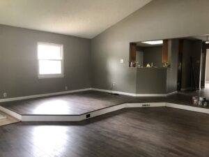 A newly remodeled interior living space with new flooring and fresh paint by Gwen Co in St. Louis, MO.