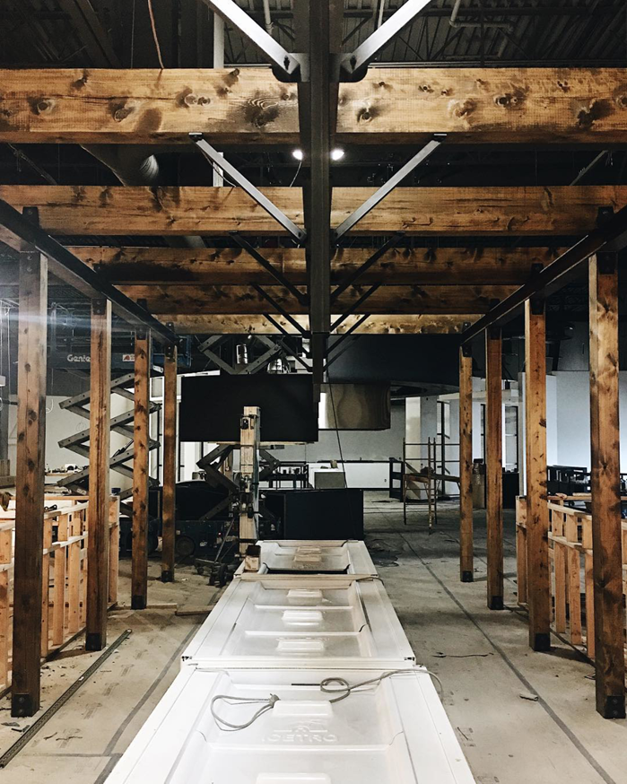 An interior renovation and construction site with exposed wooden beams and new doors ready for installation by BFC Construction in Tacoma, WA.