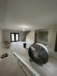 Interior home renovation in progress with a large drying fan by FG Drywall, Finishing and Painting in Champaign, IL.