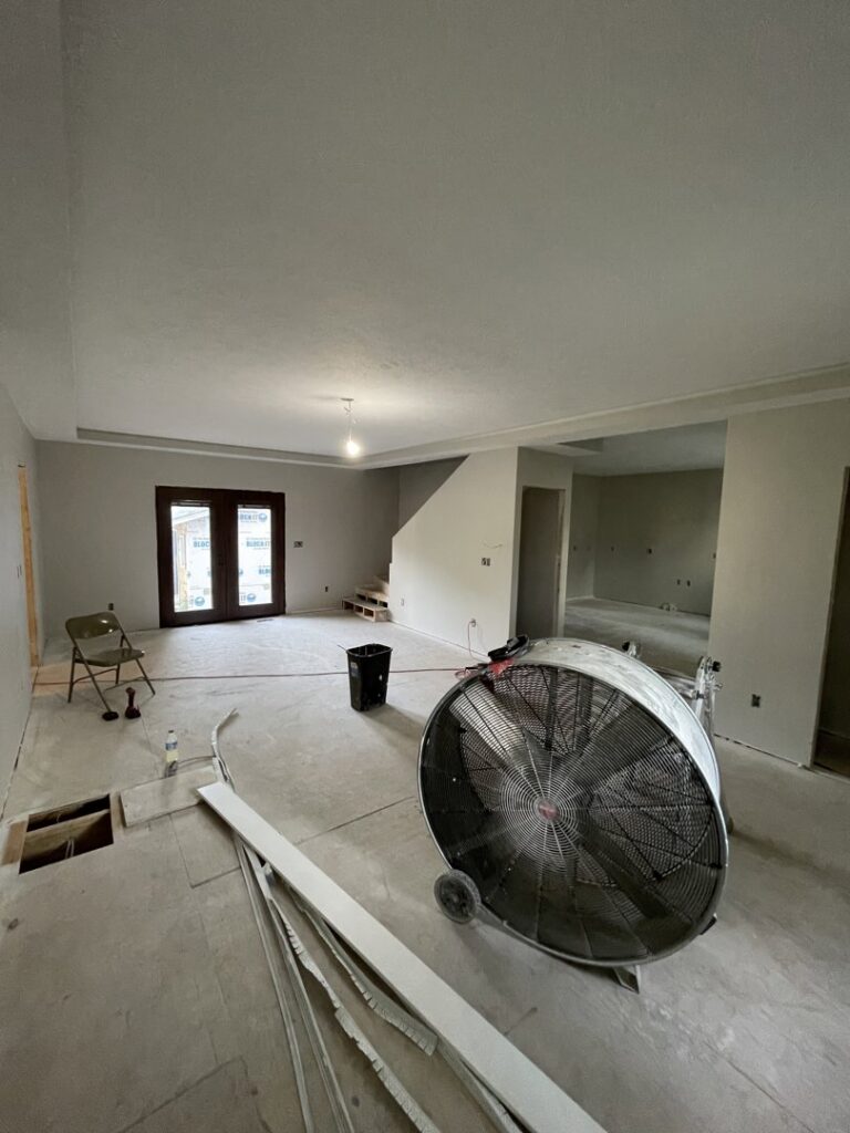 Interior home renovation in progress with a large drying fan by FG Drywall, Finishing and Painting in Champaign, IL.