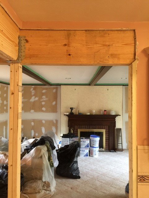 Interior renovation with exposed wooden beams and drywall work in progress by Farnsworth Interiors Drywall and Plaster in Akron, OH
