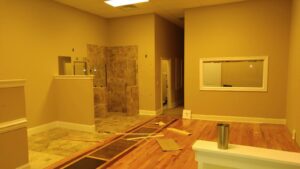 Interior renovation with new flooring and shower installation by Wall Doctor's Plastering LLC in Tallahassee, FL