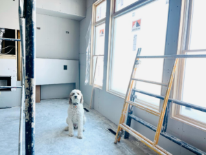 An interior room under construction with drywall and scaffolding, showing ongoing handyman work by Range Custom Homes in Rochester, MN.