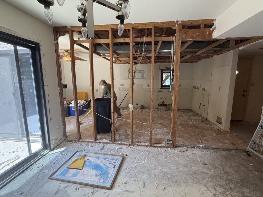 An interior room undergoing demolition with exposed studs and debris, showing a junk removal job by Southwestern Dumpster Rental and Junk Removal in Peoria, AZ.
