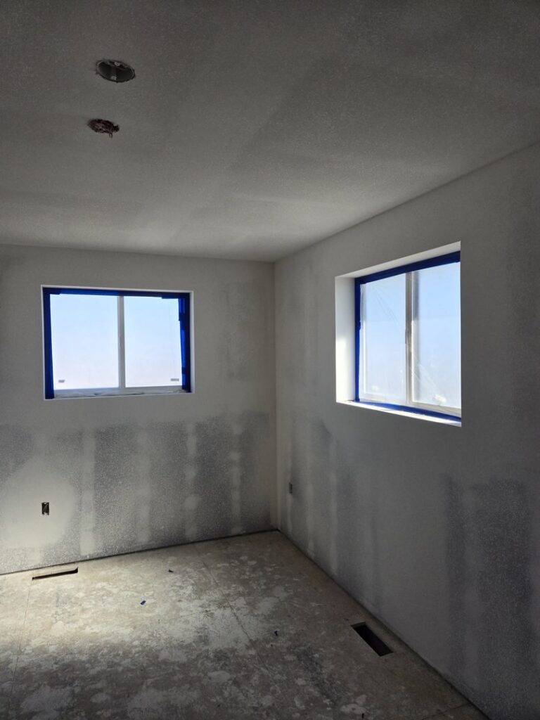 Interior room undergoing drywall finishing and painting preparation by RC Contracting in Chesterfield, MO.