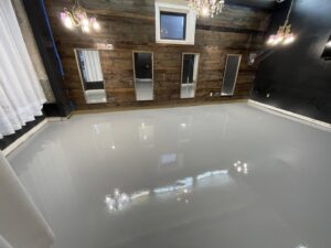 An interior room featuring a sleek grey epoxy floor installed by Premier Edge Concrete in Grand Rapids, MI