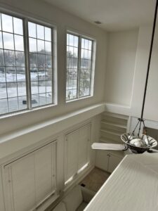 A bright interior room with high ceilings and large windows, showcasing a completed handyman painting service by Randy Overacre Painting Company in Virginia Beach, VA.