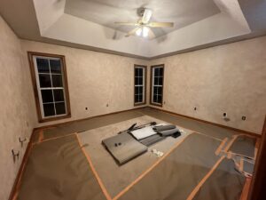 An interior room with textured walls and a tray ceiling, prepared for painting or flooring work by OG Renovations in Huntington, WV.