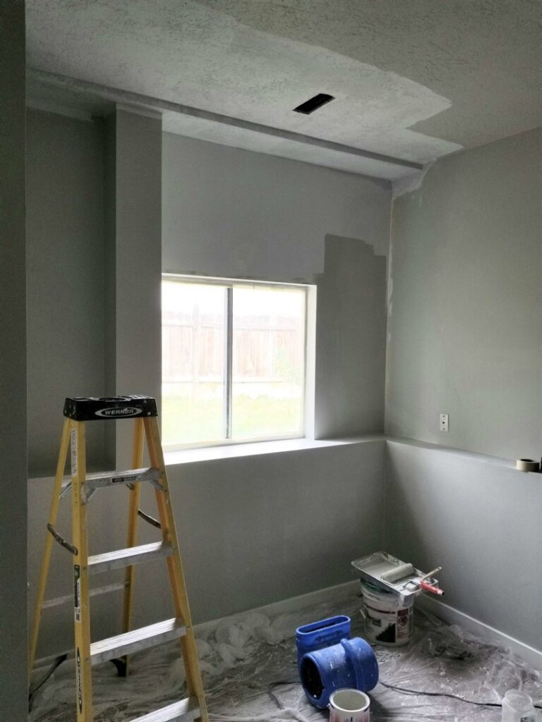 Interior room painting in progress with a ladder and supplies, a service offered by Branham Handyman in Salt Lake City, UT