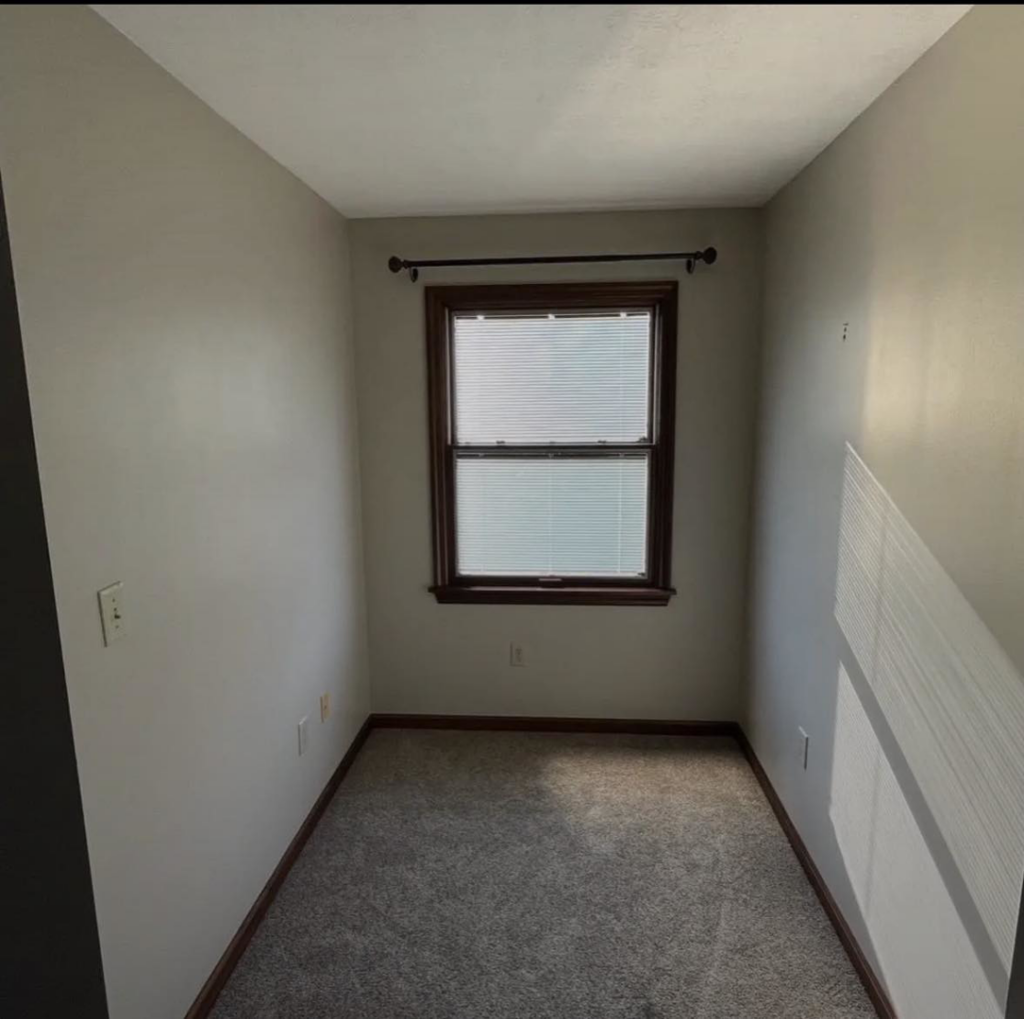 A freshly painted interior room with light gray walls by Rock Creek Renovation and Painting in Waynesville, OH