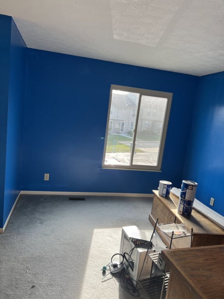 Interior room painting service with blue walls and paint cans by JW Contracting Services, LLC in Dayton, OH.