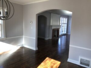 An interior room with light gray walls and white wainscoting, freshly painted by E.L. Construction in Kansas City, MO.
