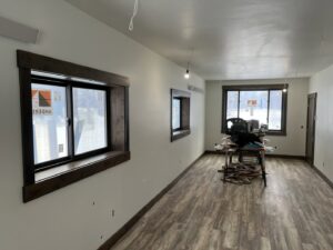 A newly renovated interior room with new flooring, painted walls, and window trim by 1775 Handyman Services in Kalispell, MT.