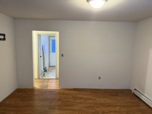 A newly renovated interior room with fresh paint and new flooring by Ground Up Services in Anchorage, AK.