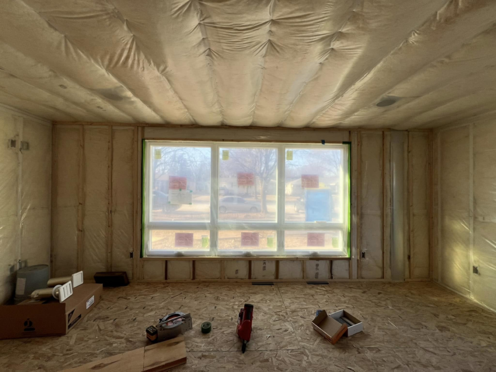 An interior room undergoing renovation with new insulation and window installation by Sandoval Contracting & Remodeling in Menasha, WI.