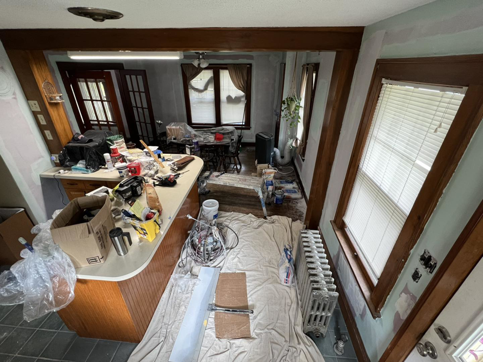 An interior room undergoing renovation with drop cloths and painting supplies by Corriveau Home Improvement LLC in Bristol, CT.