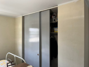 An interior room with walls prepped for painting and a closet with sliding doors by Lambert's Residential Painting And More LLC in Fort Wayne, IN.