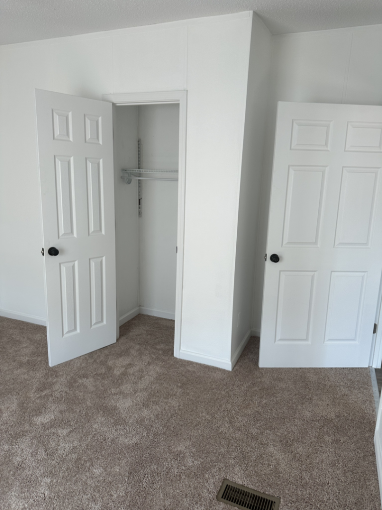 An interior room showcasing new white doors and a closet installation by ACC Construction in Knoxville, TN.
