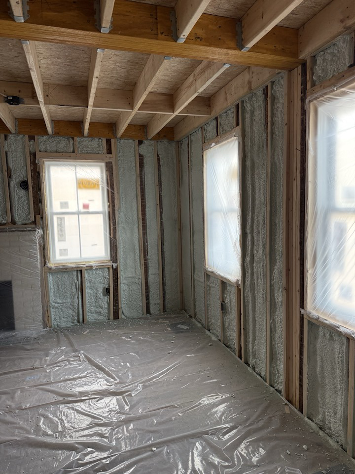 Interior room with new spray foam insulation applied to walls and windows covered by Safco Foam Insulation in Hampden, MA.