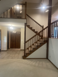 A freshly painted interior staircase and entryway, showcasing handyman painting services by K&T PRO Painting in St. Cloud, MN.