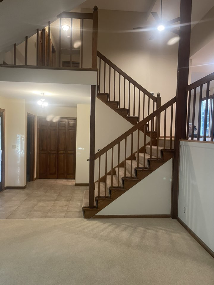 A freshly painted interior staircase and entryway, showcasing handyman painting services by K&T PRO Painting in St. Cloud, MN.