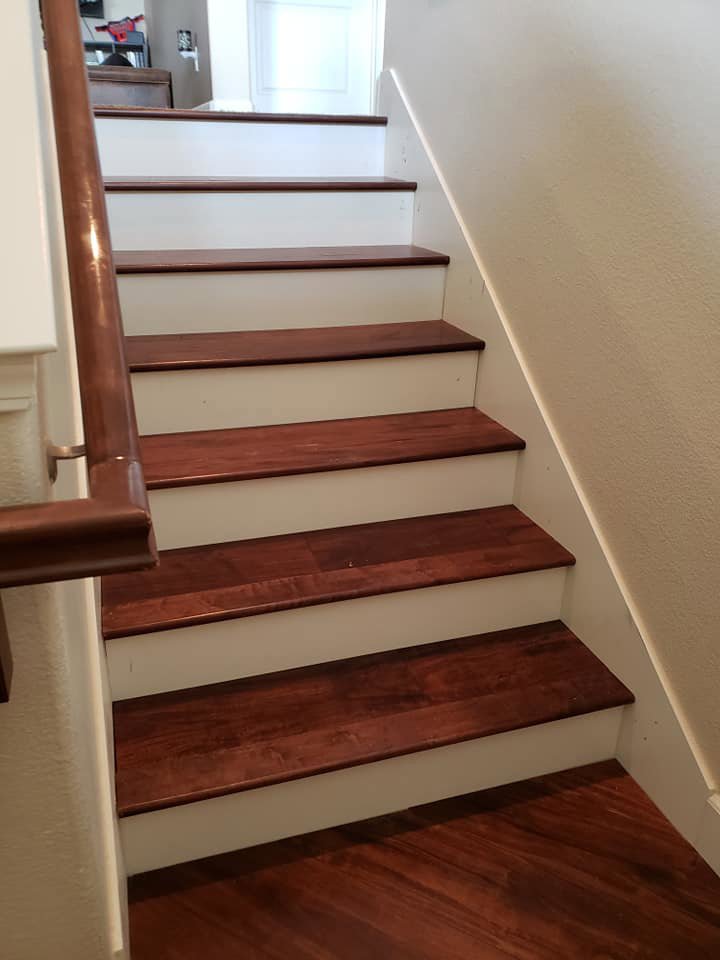 Newly renovated interior stairs featuring hardwood treads and white risers, showcasing a home improvement project by Tillman's Handyman Service in Sparks, NV.