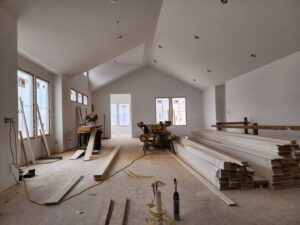 Interior room under construction with trim and flooring materials, showing handyman installation by Woods Builders in Grand Rapids, MI.