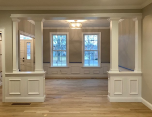 Interior room with decorative columns, wainscoting, and hardwood floors by Northeast Building Services LLC, Boston, MA.